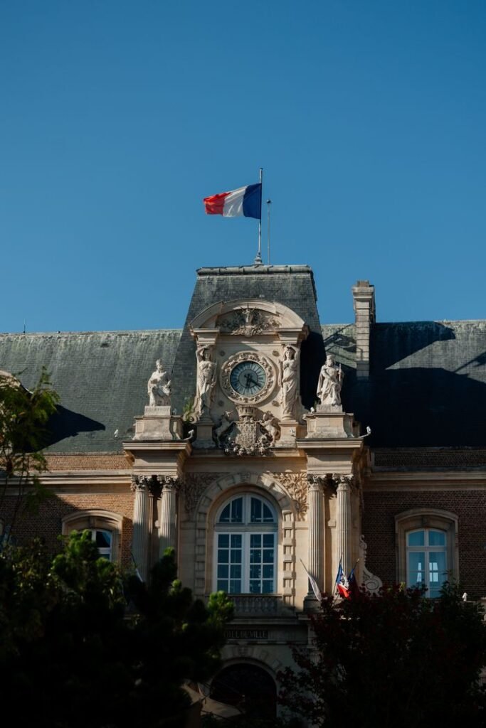 Elegant architecture of a historic building in France with a French flag flying high.